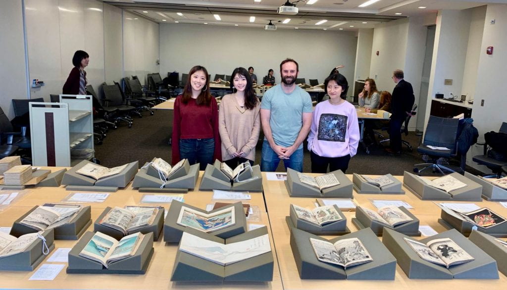 Students posing with books in the collection, Fall 2019. Photo by Yuqi Zhao.